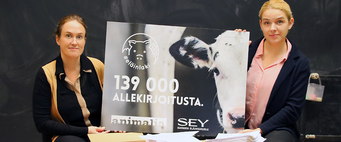 SEYn toiminnanjohtaja Kati Pulli ja Animalian toiminnanjohtaja Mai Kivelä pitävät käsissään julistetta. Siinä kerrotaan, että Eläinlaki-vetoomus keräsi 139 000 allekirjoitusta.